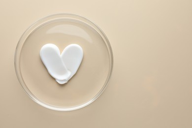 Photo of Cosmetic product in Petri dish on beige background, top view. Space for text