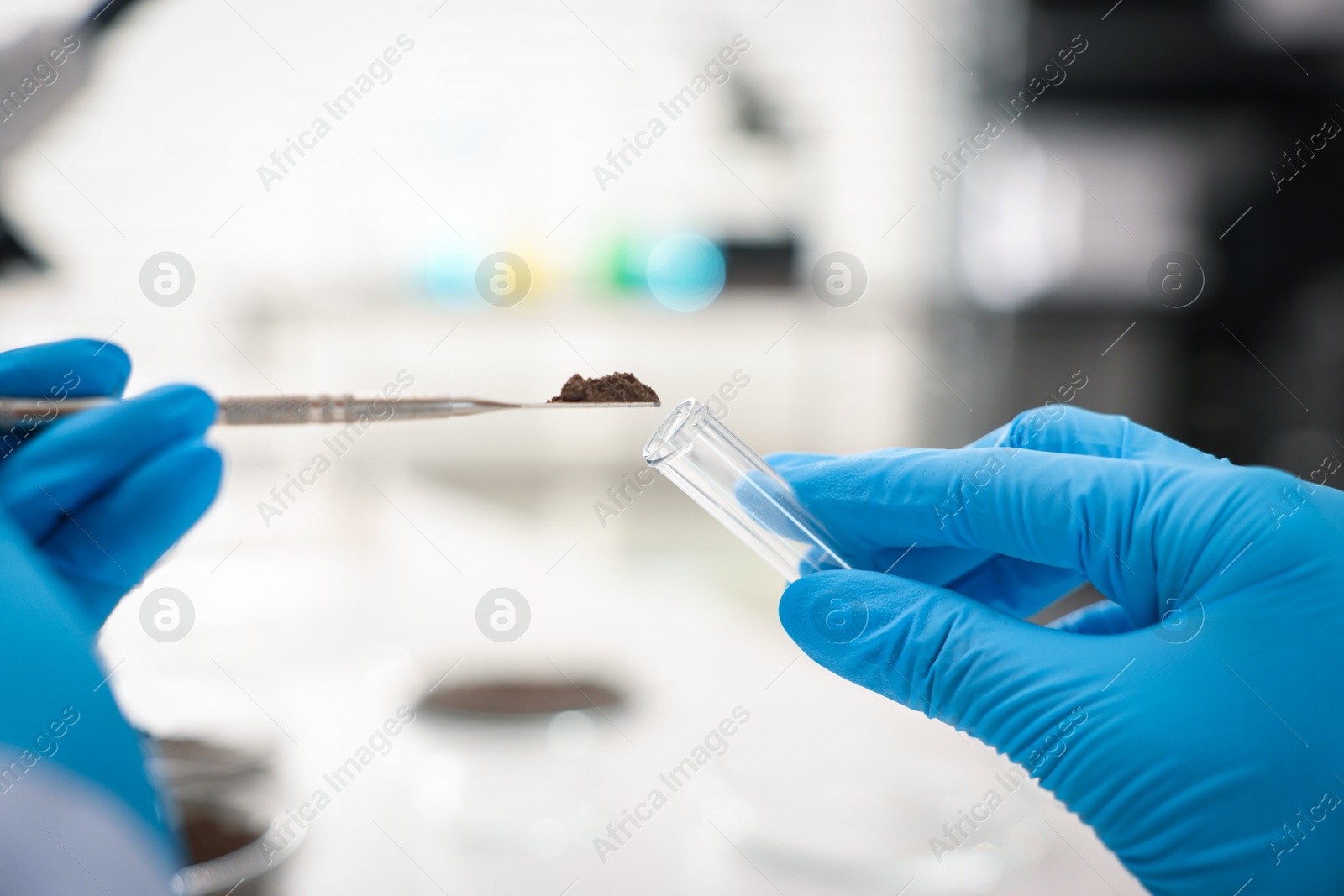 Scientist taking soil sample for research in laboratory, closeup Photo of Scientist taking soil sample for research in laboratory, closeup
