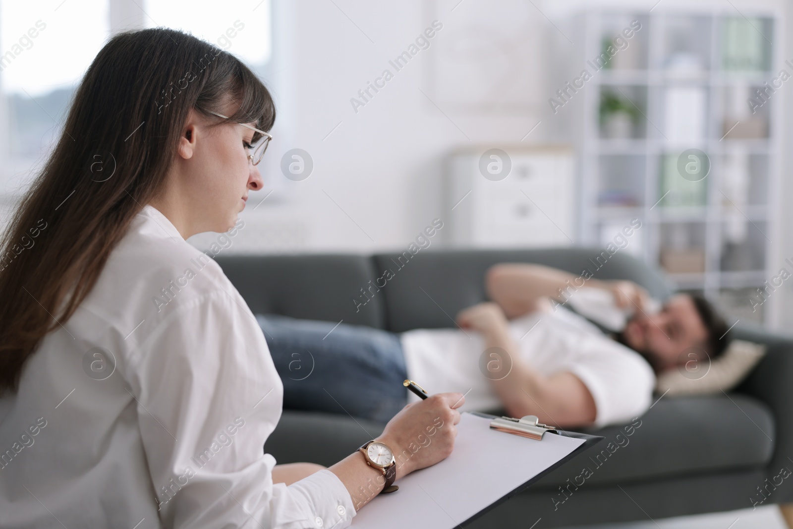 Professional psychologist working with patient in office, selective focus Photo of Professional psychologist working with patient in office, selective focus