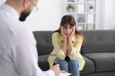 Photo of Professional psychologist working with patient in office, selective focus