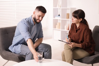 Photo of Professional psychologist working with patient in office