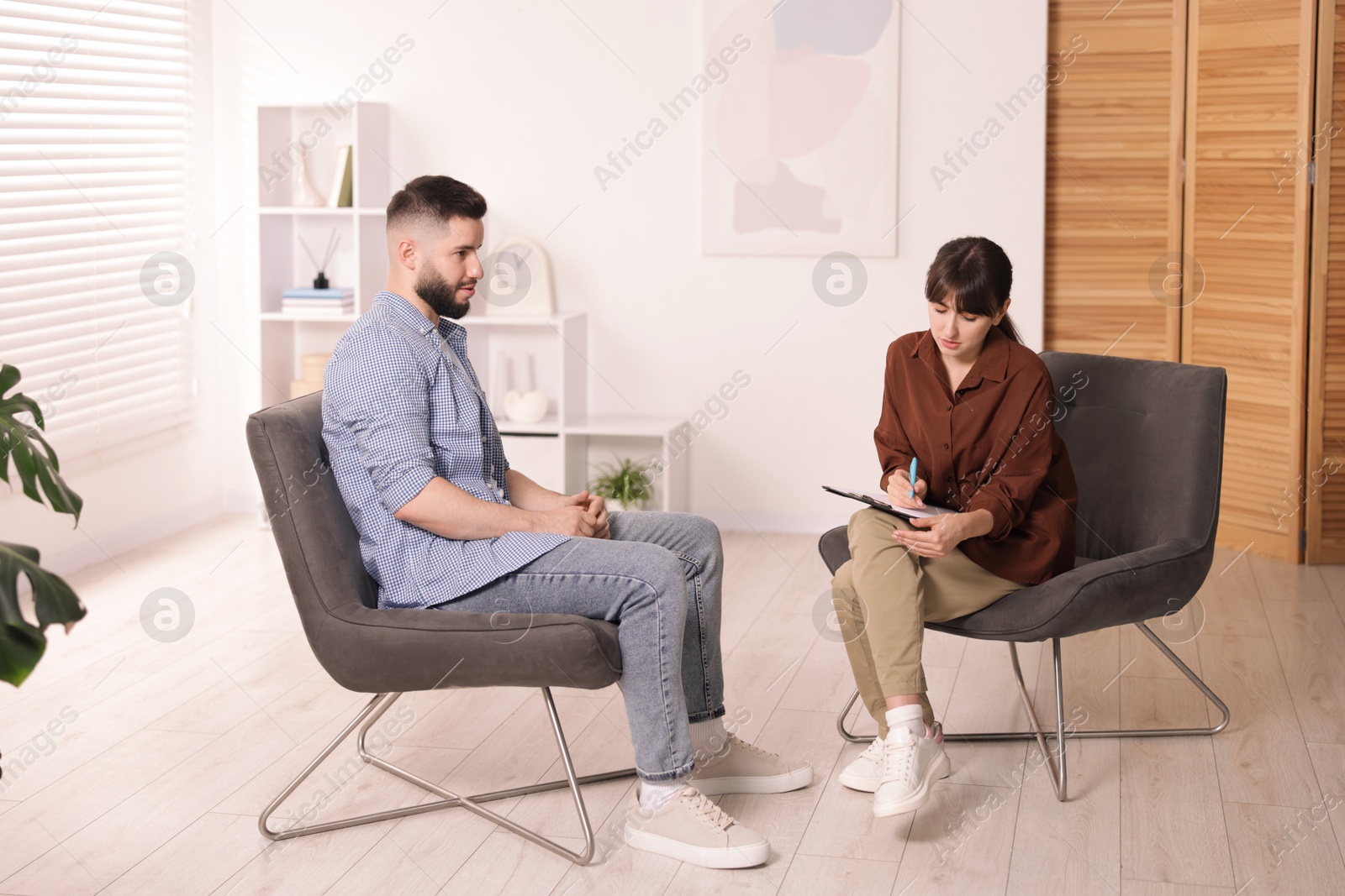 Professional psychologist working with patient in office Photo of Professional psychologist working with patient in office