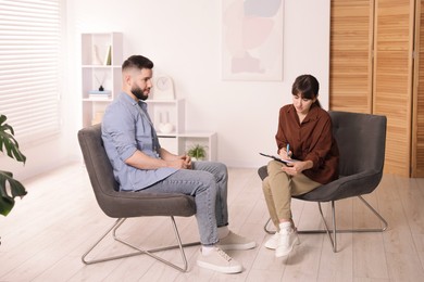 Photo of Professional psychologist working with patient in office