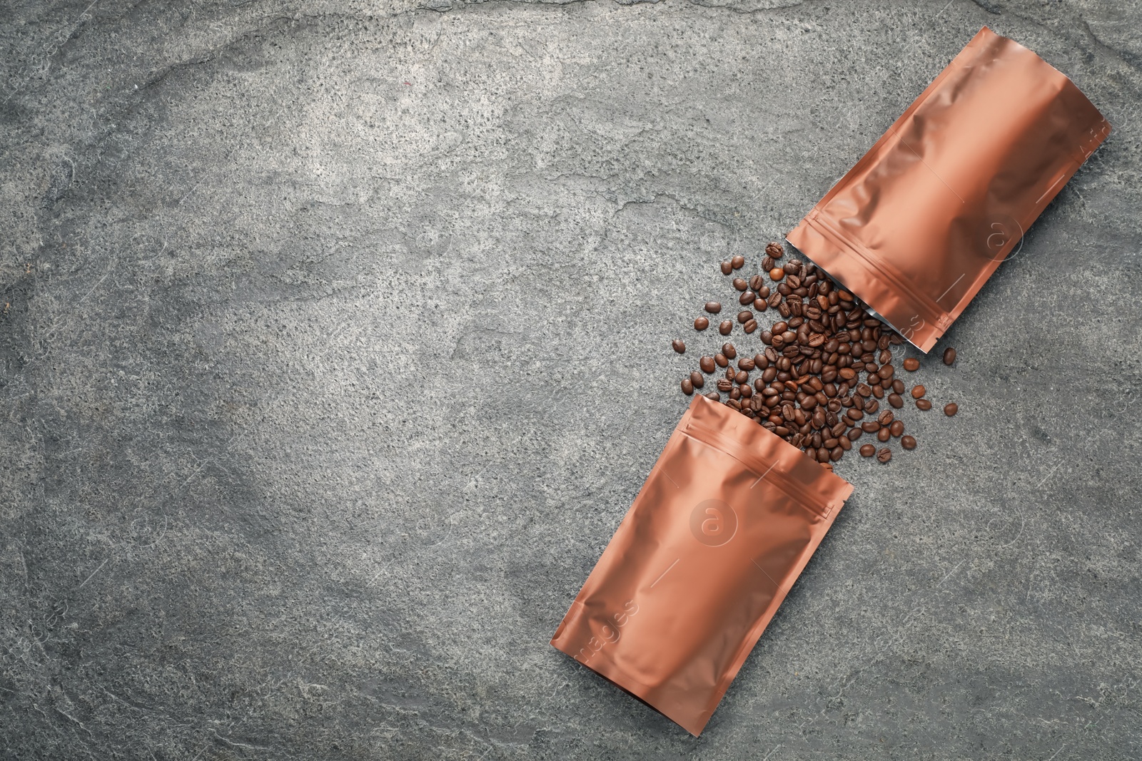 Zipper stand-up pouches and coffee beans on grey table, flat lay. Mockup for design Photo of Zipper stand-up pouches and coffee beans on grey table, flat lay. Mockup for design