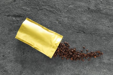 Photo of Zipper stand-up pouch and coffee beans on grey table, flat lay. Mockup for design