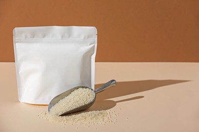 Photo of Zipper stand-up pouch and white rice on color background, mockup for design
