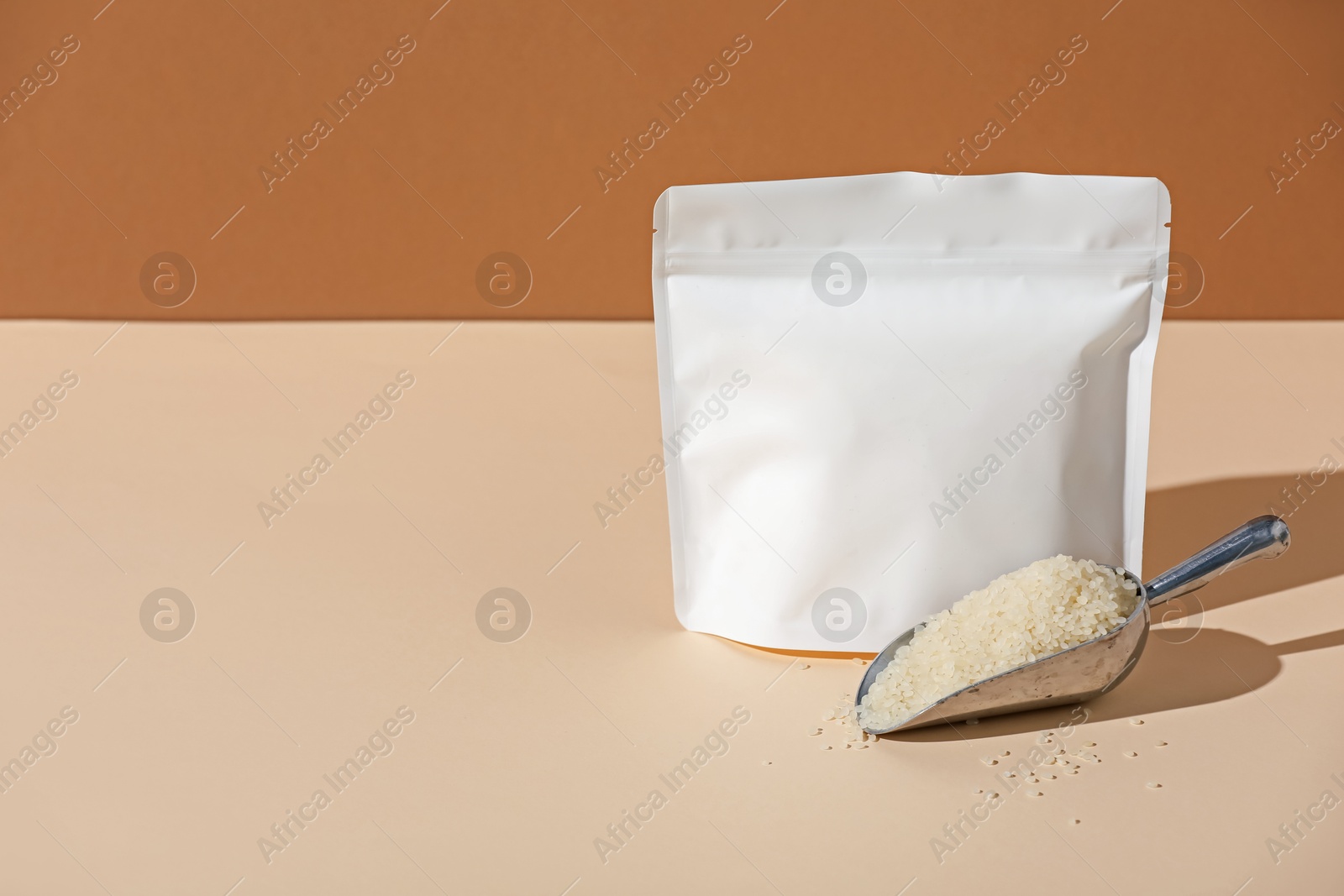 Zipper stand-up pouch and white rice on color background, mockup for design Photo of Zipper stand-up pouch and white rice on color background, mockup for design