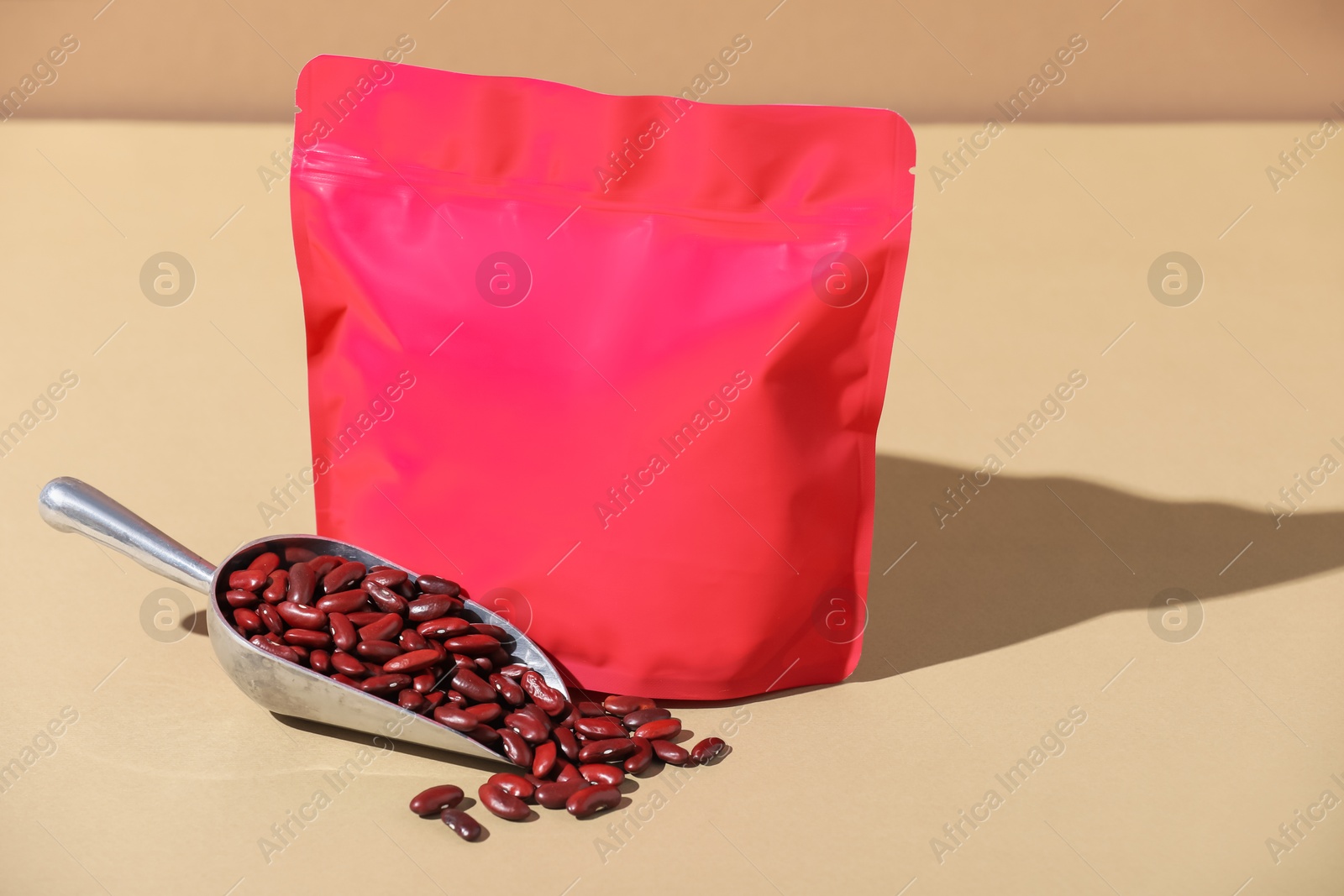Zipper stand-up pouch and dry kidney beans on beige background, mockup for design Photo of Zipper stand-up pouch and dry kidney beans on beige background, mockup for design