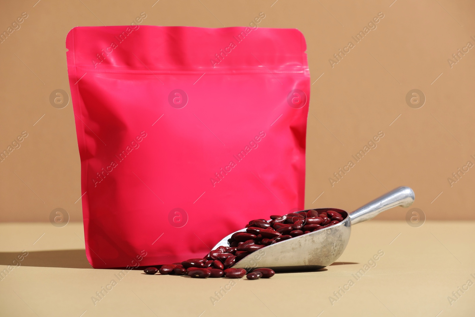 Zipper stand-up pouch and dry kidney beans on beige background, closeup. Mockup for design Photo of Zipper stand-up pouch and dry kidney beans on beige background, closeup. Mockup for design