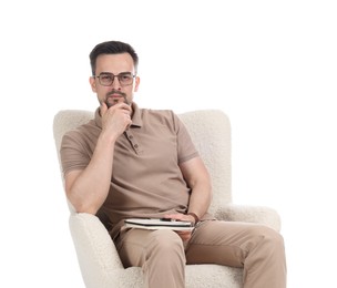 Photo of Professional psychologist with notebook in armchair on white background