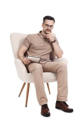 Photo of Professional psychologist with notebook in armchair on white background