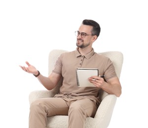 Photo of Professional psychologist with notebook in armchair on white background