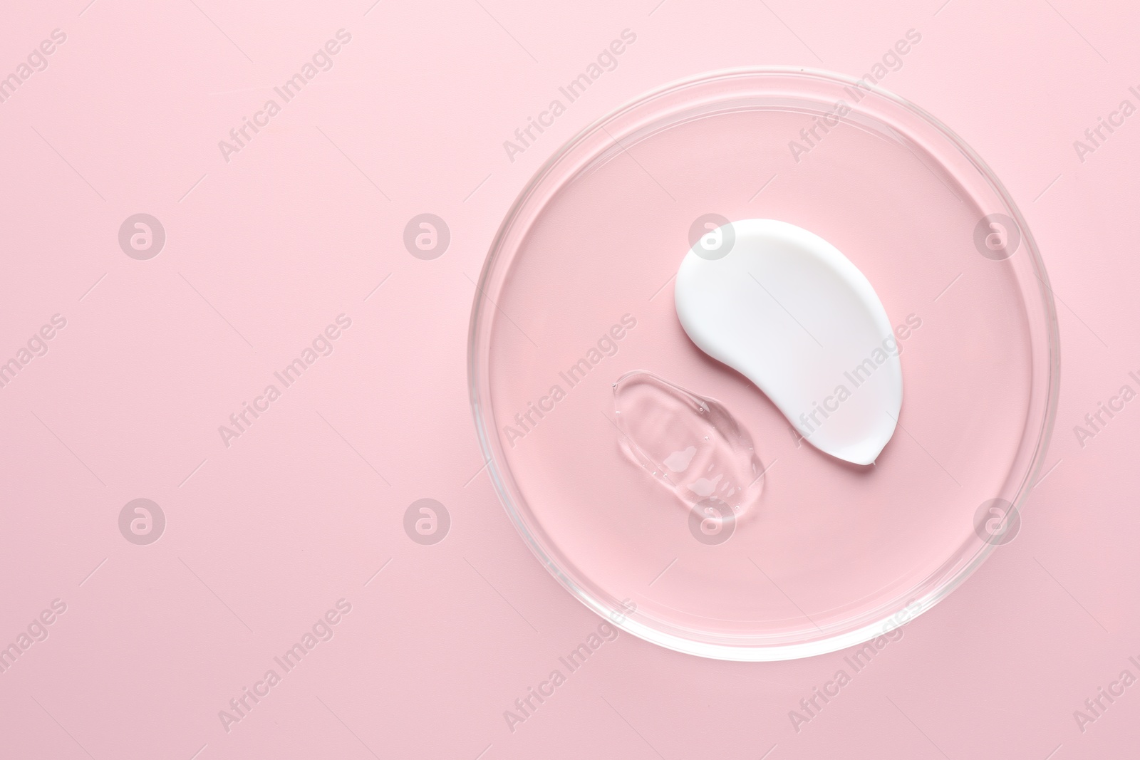 Different cosmetic products in Petri dish on pink background, top view. Space for text Photo of Different cosmetic products in Petri dish on pink background, top view. Space for text
