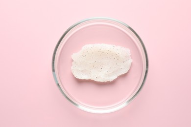 Photo of Cosmetic product in Petri dish on pink background, top view