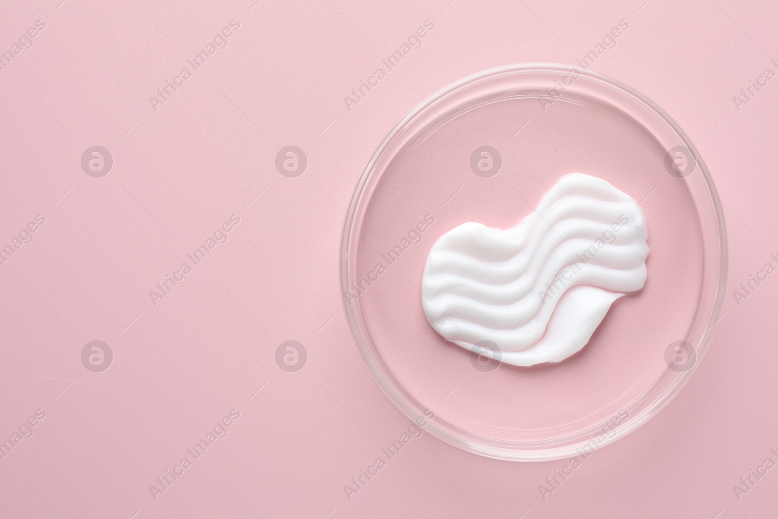 Cosmetic product in Petri dish on pink background, top view. Space for text Photo of Cosmetic product in Petri dish on pink background, top view. Space for text