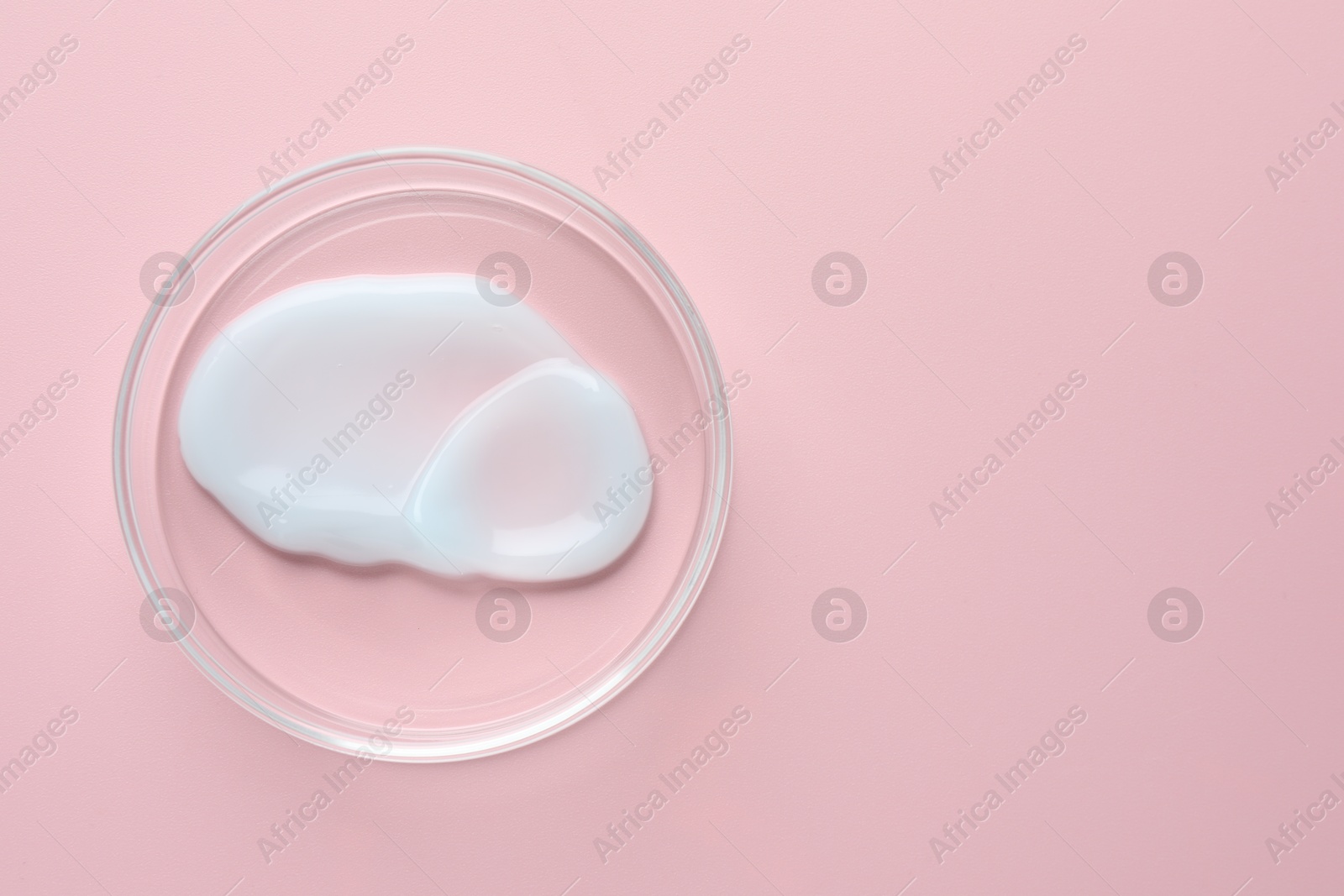 Cosmetic product in Petri dish on pink background, top view. Space for text Photo of Cosmetic product in Petri dish on pink background, top view. Space for text