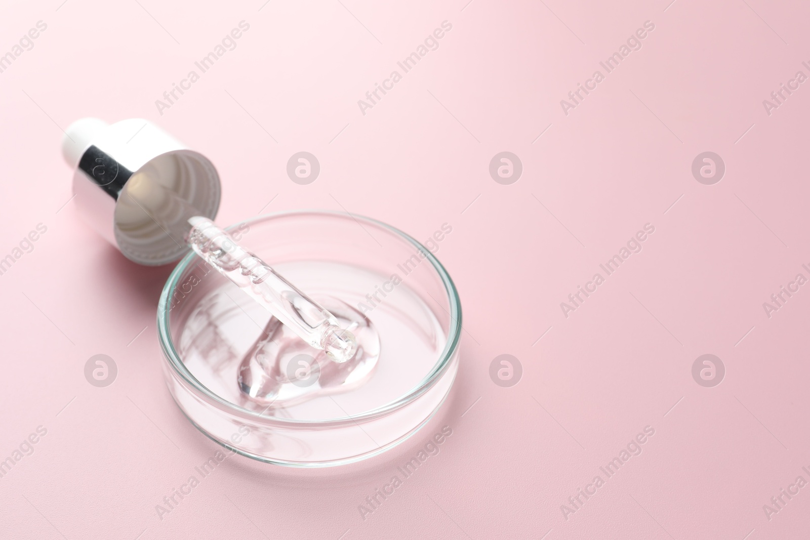 Cosmetic product in Petri dish and dropper on pink background, closeup. Space for text Photo of Cosmetic product in Petri dish and dropper on pink background, closeup. Space for text