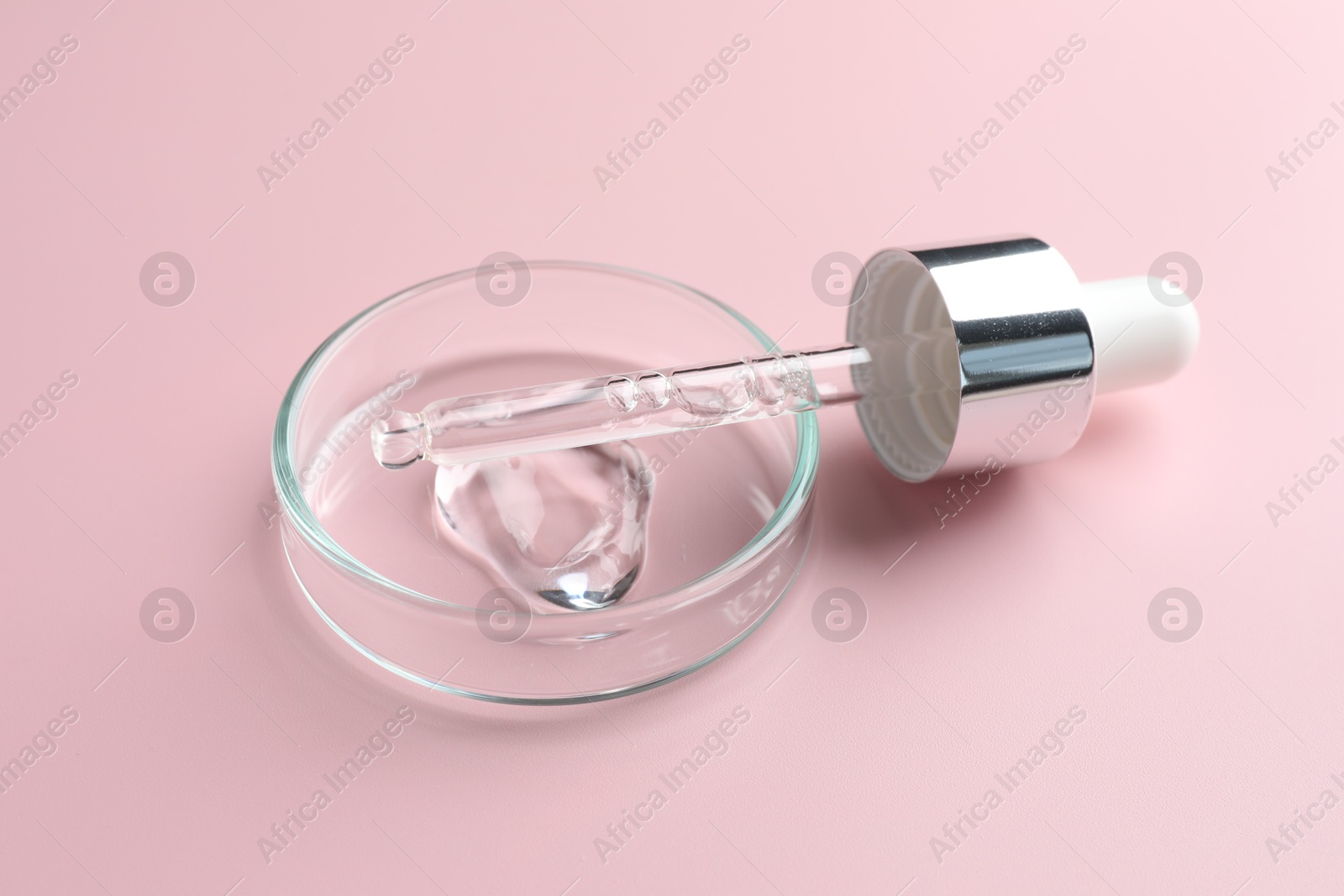 Cosmetic product in Petri dish and dropper on pink background, closeup Photo of Cosmetic product in Petri dish and dropper on pink background, closeup