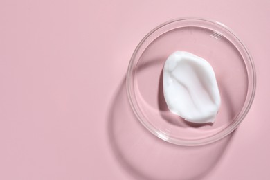 Photo of Cosmetic product in Petri dish on pink background, top view. Space for text