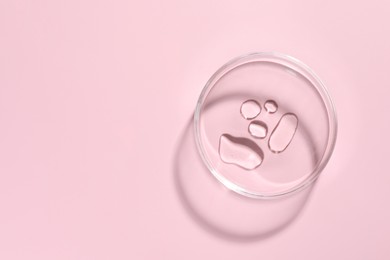 Photo of Cosmetic product in Petri dish on pink background, top view. Space for text