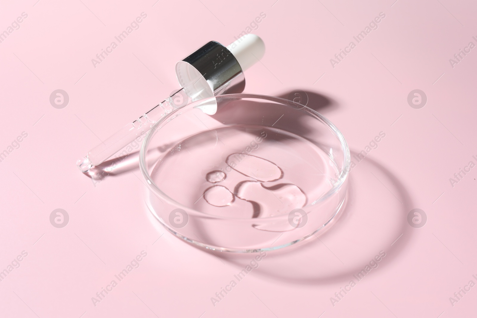 Cosmetic product in Petri dish and dropper on pink background, closeup Photo of Cosmetic product in Petri dish and dropper on pink background, closeup