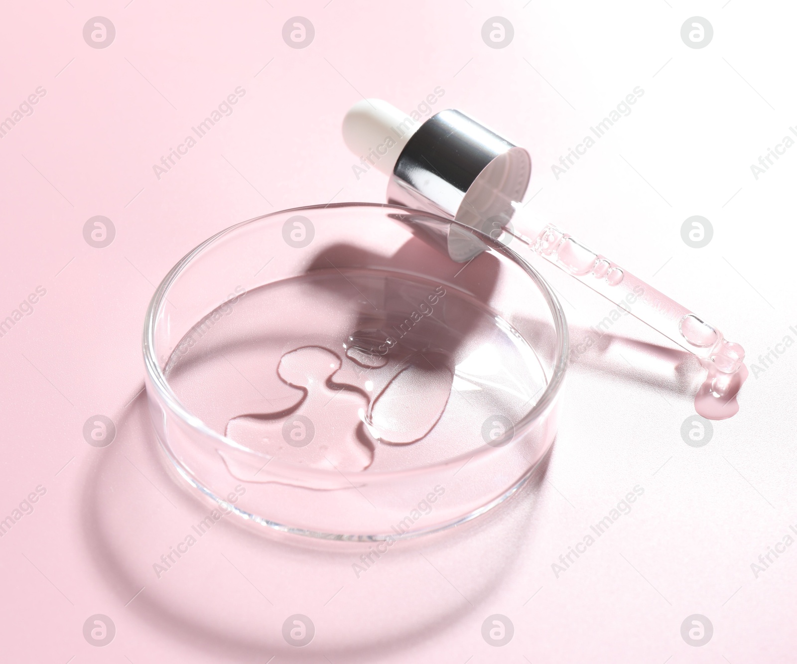 Cosmetic product in Petri dish and dropper on pink background, closeup Photo of Cosmetic product in Petri dish and dropper on pink background, closeup