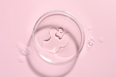 Photo of Cosmetic product in Petri dish on pink background, top view