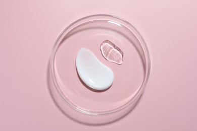 Photo of Different cosmetic products in Petri dish on pink background, top view