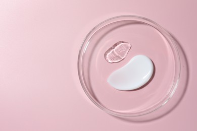 Photo of Different cosmetic products in Petri dish on pink background, top view. Space for text