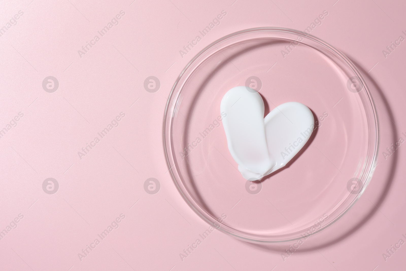 Cosmetic product in Petri dish on pink background, top view. Space for text Photo of Cosmetic product in Petri dish on pink background, top view. Space for text