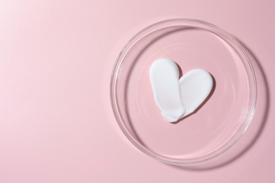 Photo of Cosmetic product in Petri dish on pink background, top view. Space for text