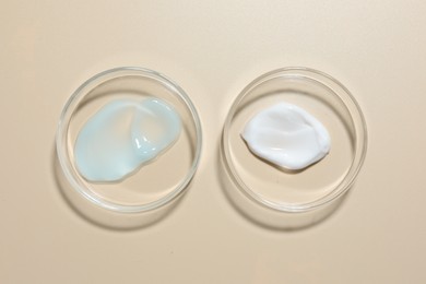 Photo of Different cosmetic products in Petri dishes on beige background, flat lay