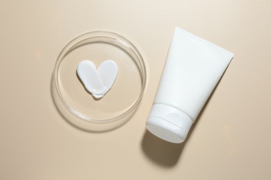 Photo of Cosmetic product in Petri dish and tube on beige background, flat lay