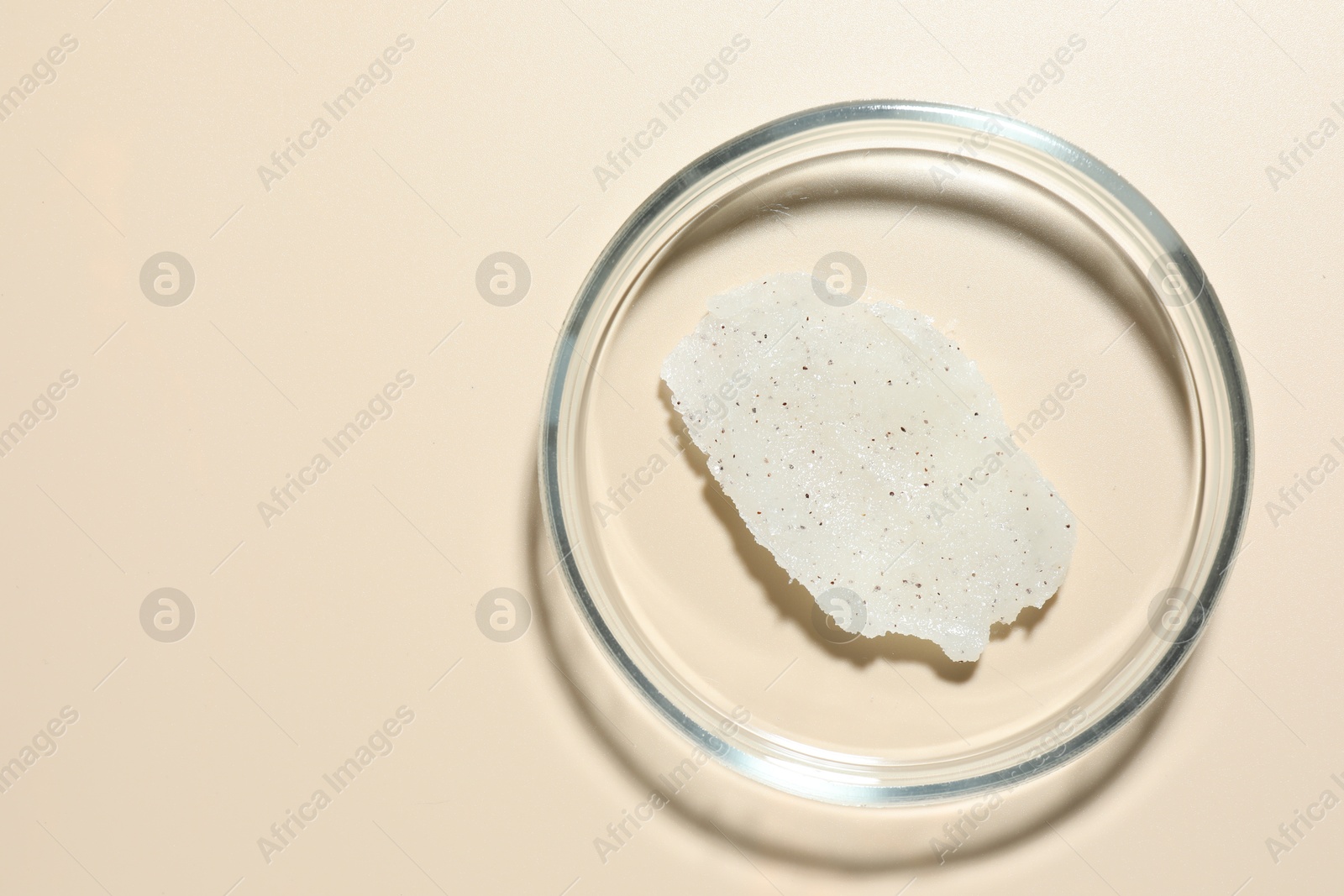 Cosmetic product in Petri dish on beige background, top view. Space for text Photo of Cosmetic product in Petri dish on beige background, top view. Space for text