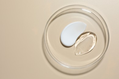 Photo of Different cosmetic products in Petri dish on beige background, top view. Space for text