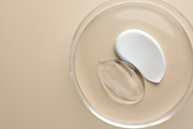 Photo of Different cosmetic products in Petri dish on beige background, top view. Space for text