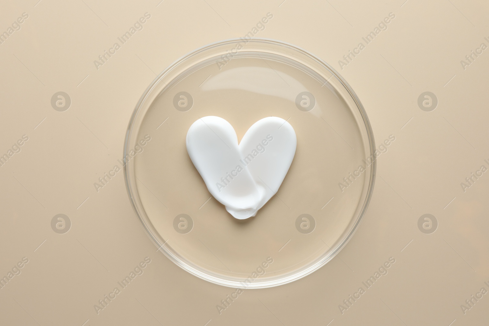Cosmetic product in Petri dish on beige background, top view Photo of Cosmetic product in Petri dish on beige background, top view