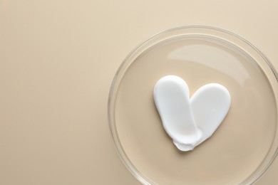 Photo of Cosmetic product in Petri dish on beige background, top view. Space for text