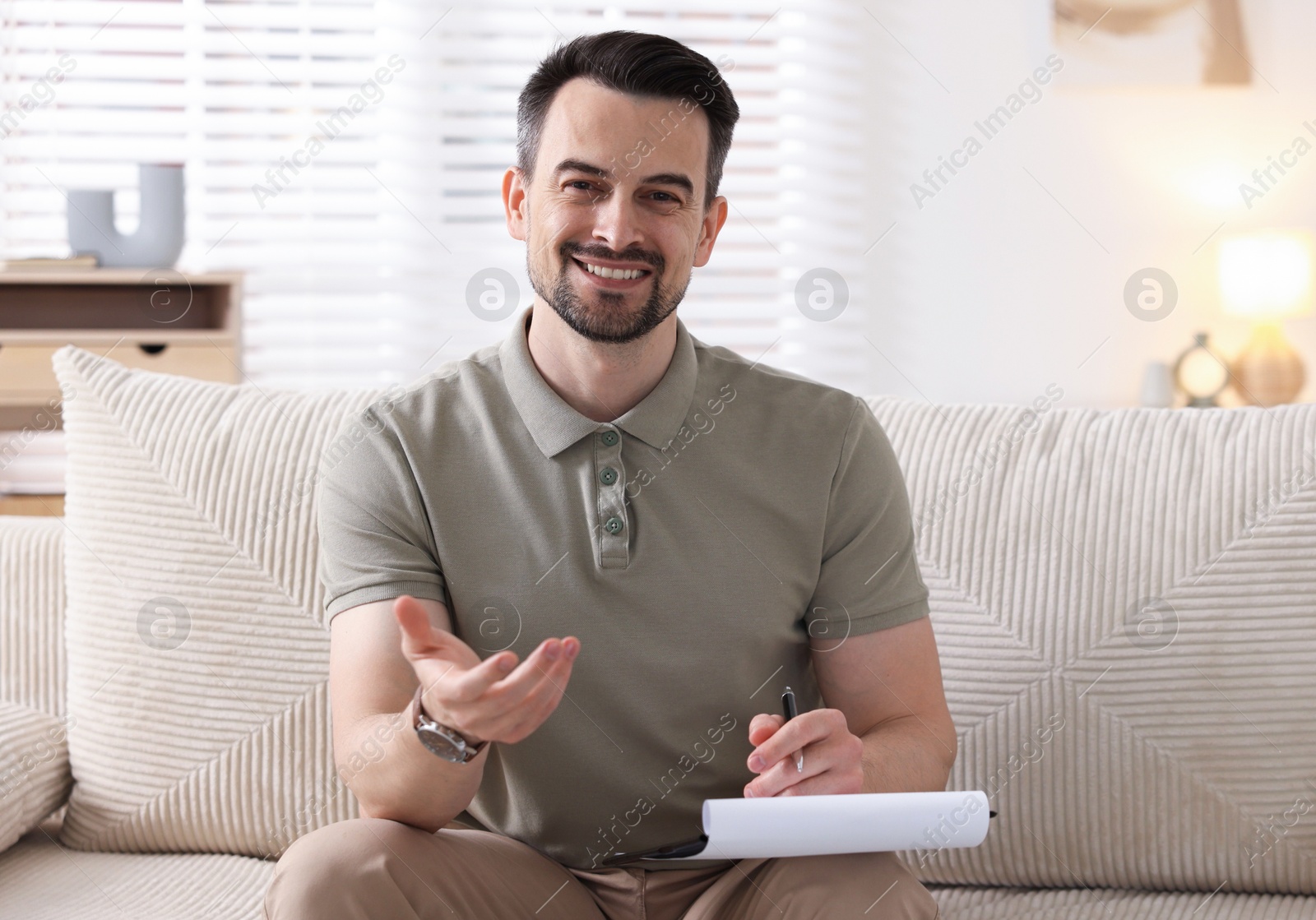 Professional psychologist with clipboard in his office Photo of Professional psychologist with clipboard in his office