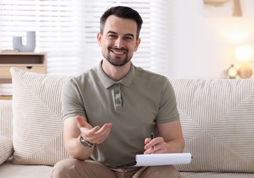Photo of Professional psychologist with clipboard in his office