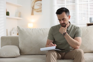 Photo of Professional psychologist with clipboard in his office. Space for text