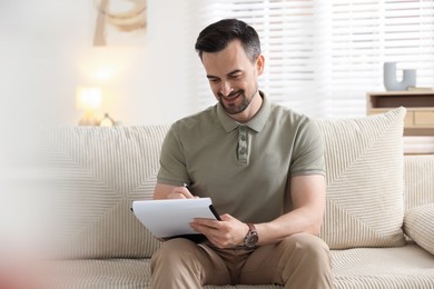 Photo of Professional psychologist with clipboard in his office