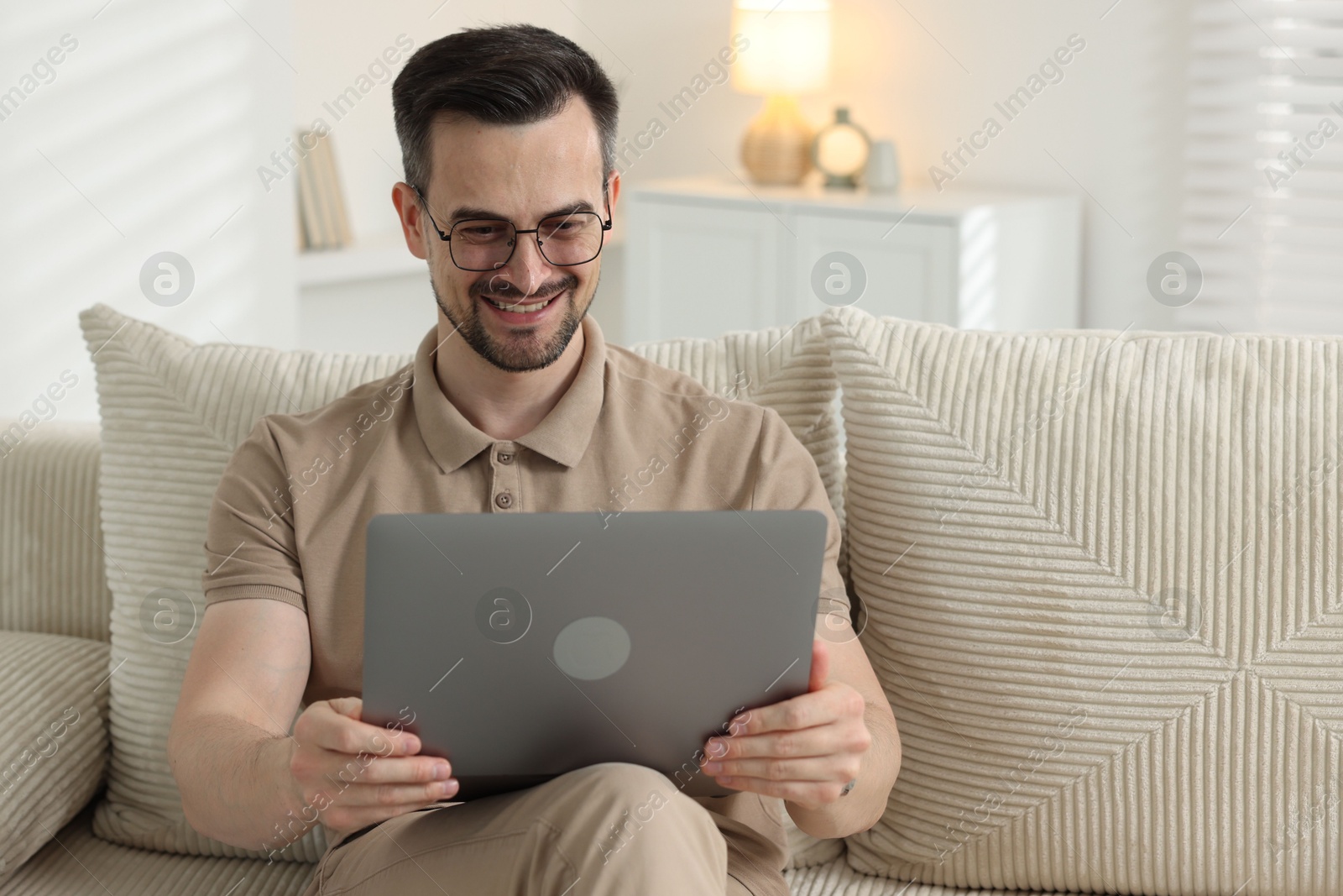 Professional psychologist having online consultation with his client via laptop on sofa indoors Photo of Professional psychologist having online consultation with his client via laptop on sofa indoors