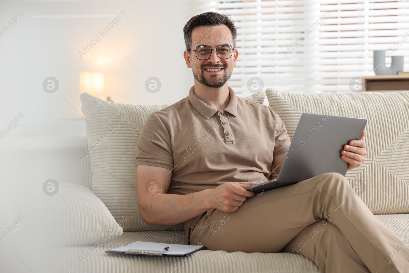 Professional psychologist having online consultation with his client via laptop on sofa indoors Photo of Professional psychologist having online consultation with his client via laptop on sofa indoors