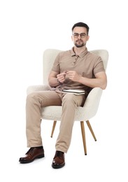 Photo of Professional psychologist with notebook in armchair on white background