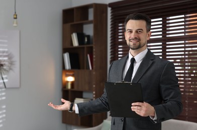 Photo of Professional psychologist with clipboard inviting to his office. Space for text