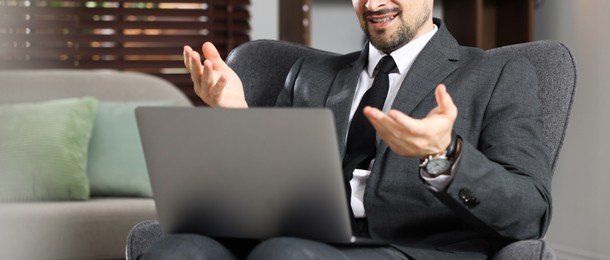 Photo of Professional psychologist having online consultation with his client via laptop indoors, closeup