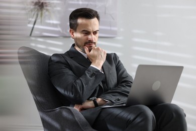 Photo of Professional psychologist having online consultation with his client via laptop indoors
