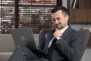 Photo of Professional psychologist having online consultation with his client via laptop indoors