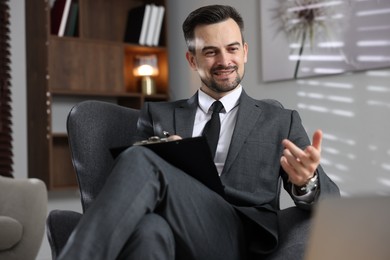 Photo of Professional psychologist having online consultation with his client via laptop indoors